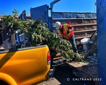Caltrans employee unloading trash from a yellow pick up truck. For more information, call (619) 688-6670 or email CT.Public.Information.D11@dot.ca.gov