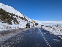 Construction equipment removes snow and debris from the south side of the avalanche on U.S. 395 along Mono Lake in March 2023.