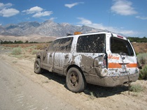 A Caltrans vehicle sits damaged on the side of the road following flash floods and debris flows in Independence in July, 2008.