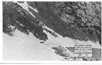 A black and white photo of Tioga Road covered in snow in 1934. A sign in the picture reads "Snow Removal Program. 9-Mono County-40-A Mile 10.5. March 29, 1934. 68KG. State of California Department of Public Works. Division of Highways District 9, Bishop California."
