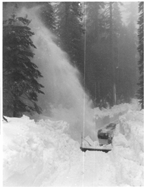 A black and white image of a snowblower blowing snow off the road on State Route 120 W to Yosemite in 1983.